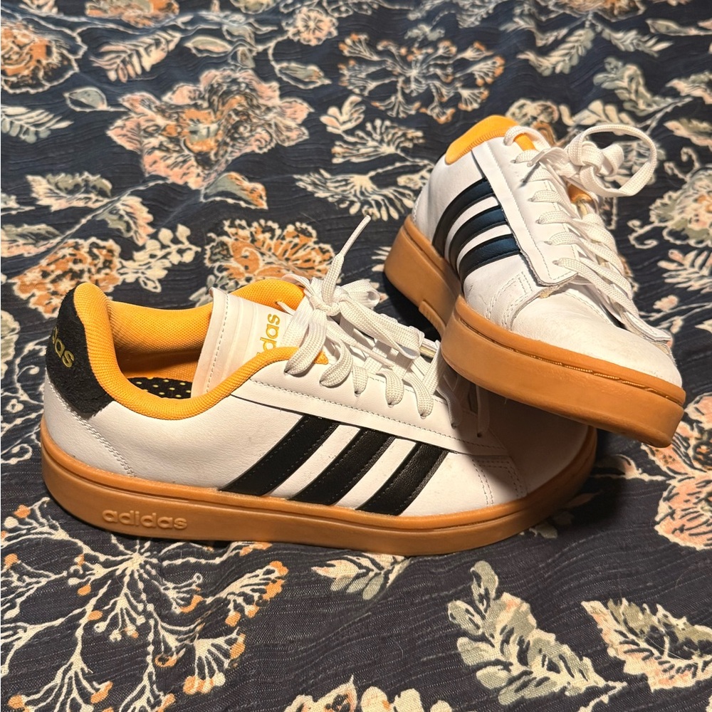 Adidas Women's White Sneakers with Black Stripes and Orange Sole